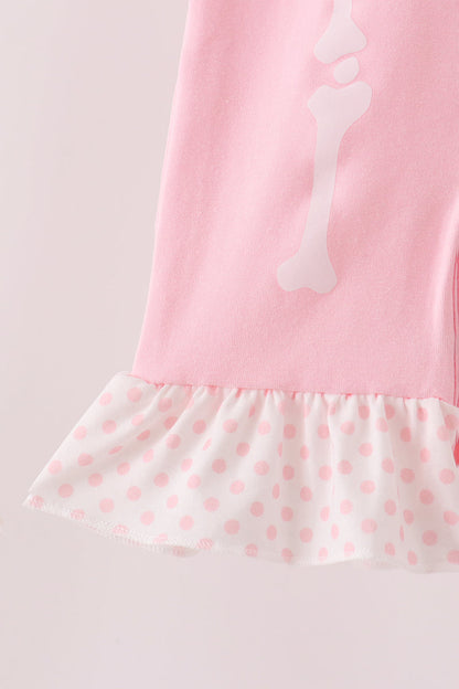 Pink skeleton print ruffle romper