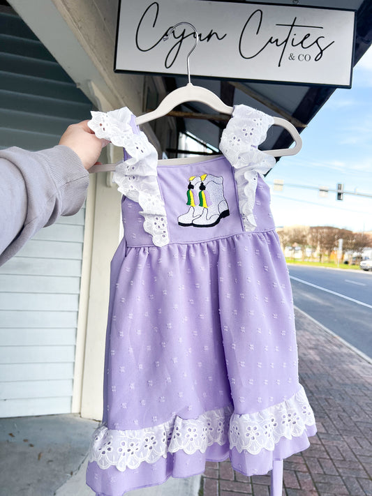 Child’s Mardi Gras dress in Swiss dot pattern, featuring traditional carnival colors of purple, green, and gold