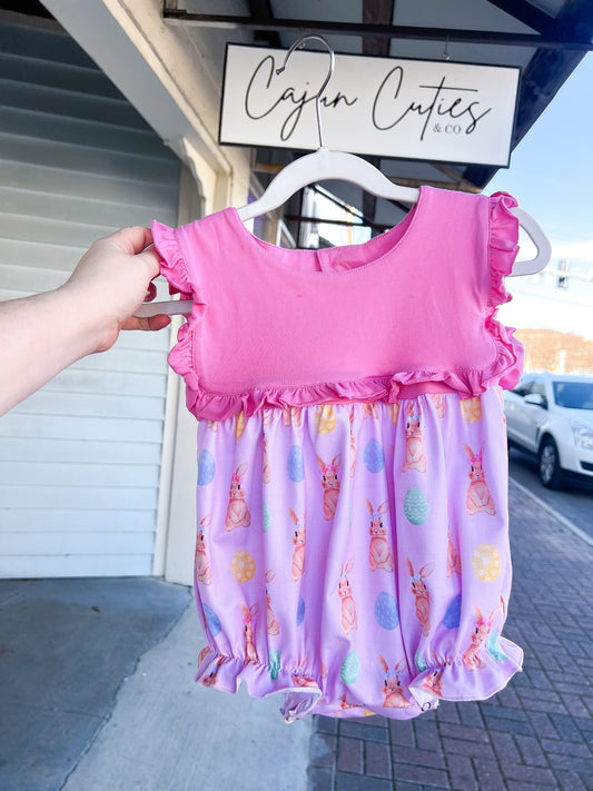 "Little girl wearing pink Easter Bunny bubble with embroidered bunny and colorful eggs, ideal for Easter celebrations."