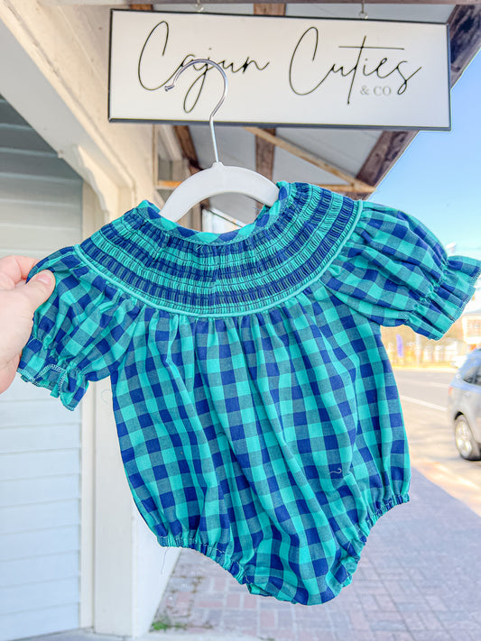 Infant wearing a green and navy blue plaid bubble outfit, ideal for stylish comfort and playful days.