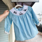 Baby blue smocked outfit for infants featuring a beautifully detailed navy nativity scene, ideal for the holiday season