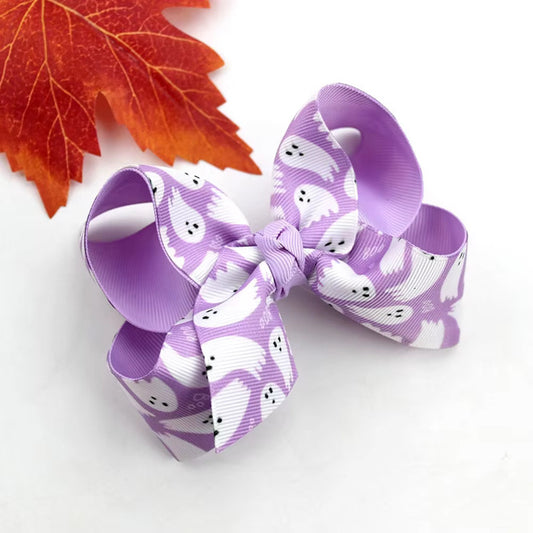Purple hair bow with ghost pattern on a white background