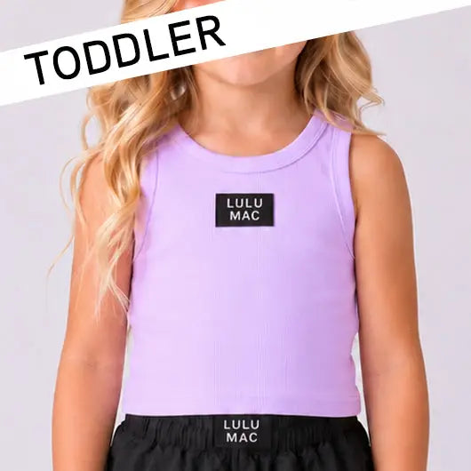 Toddler girl wearing a Lulu Mac lavender ribbed tank top boutique summer outfit.